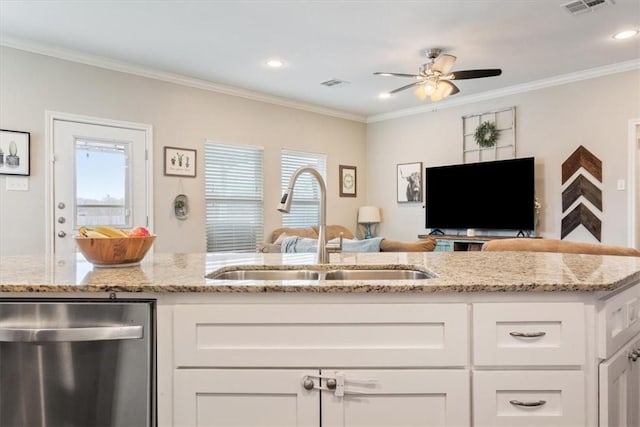 kitchen featuring light stone counters, sink, white cabinets, and ornamental molding