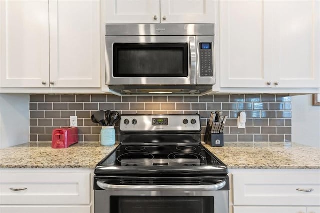 kitchen with backsplash, white cabinetry, and appliances with stainless steel finishes