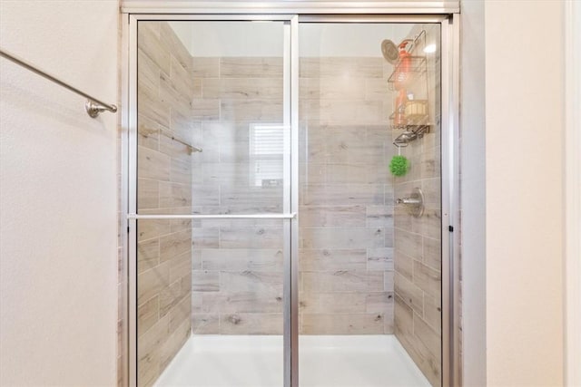 bathroom with a shower with shower door