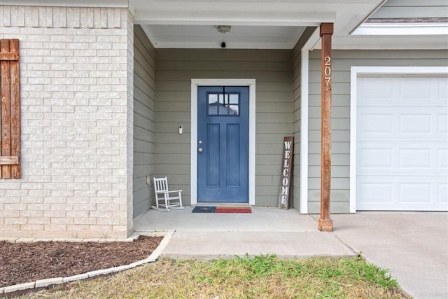 view of exterior entry with a garage