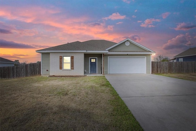 view of front of property featuring a lawn and a garage