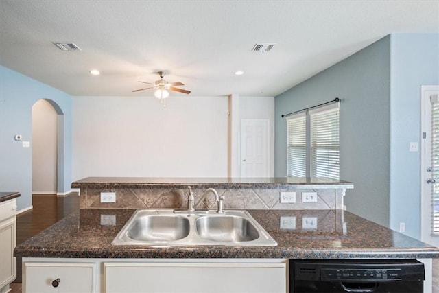 kitchen featuring a kitchen island with sink, sink, white cabinets, and black dishwasher