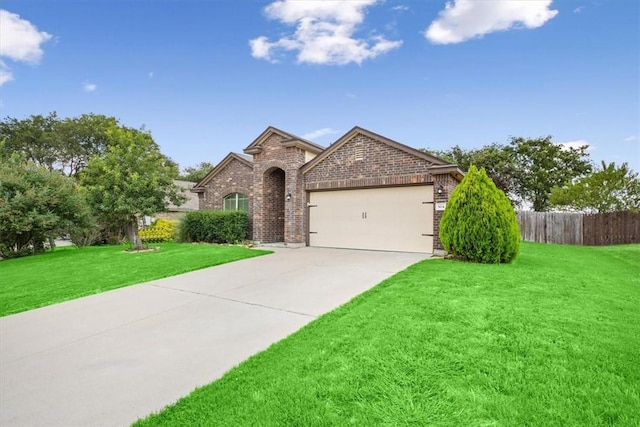 view of front of house featuring a front yard and a garage