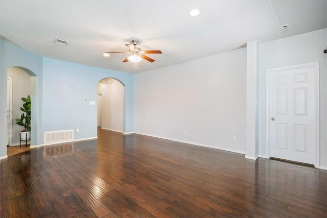 empty room with ceiling fan and dark wood-type flooring