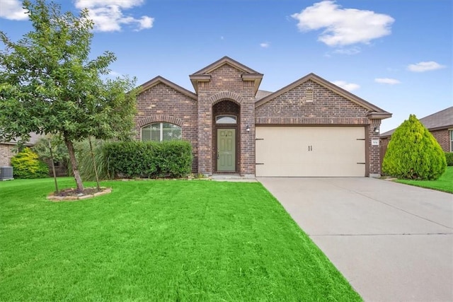 view of front of property with cooling unit, a garage, and a front yard