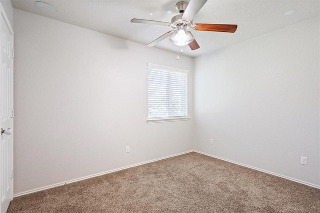 empty room featuring carpet and ceiling fan