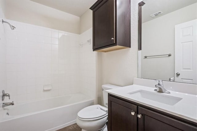 full bathroom with vanity, toilet, and tiled shower / bath combo