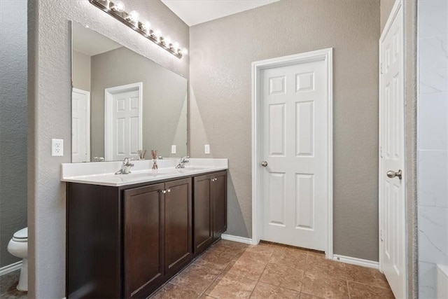 bathroom featuring tile patterned floors, vanity, and toilet