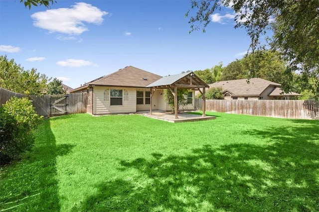 rear view of property with a yard and a patio