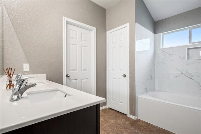 bathroom with tile patterned floors, vanity, and tiled shower / bath