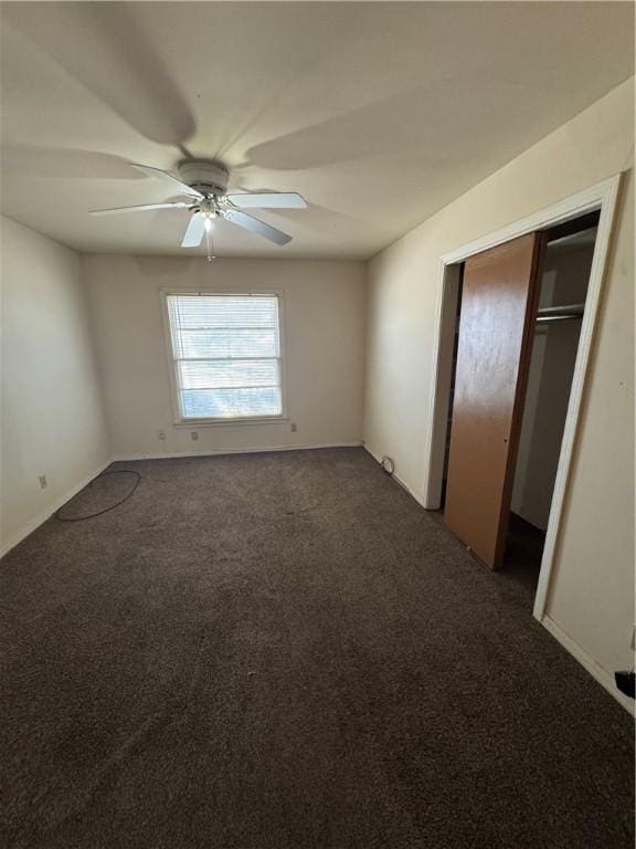 unfurnished bedroom featuring ceiling fan, a closet, and carpet flooring