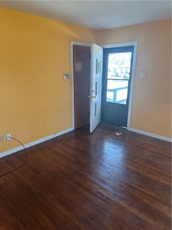 entryway featuring dark wood-style flooring and baseboards