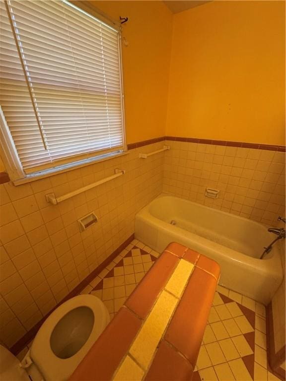 full bath with tile walls, a bath, and tile patterned floors