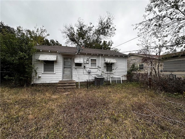 rear view of house featuring central AC unit