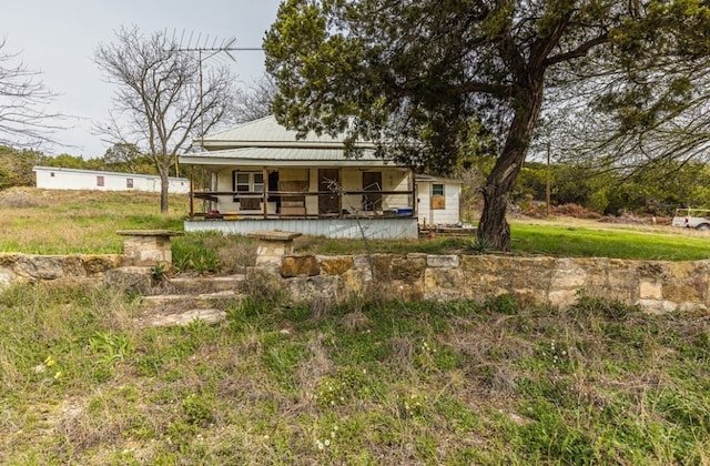 rear view of property with covered porch