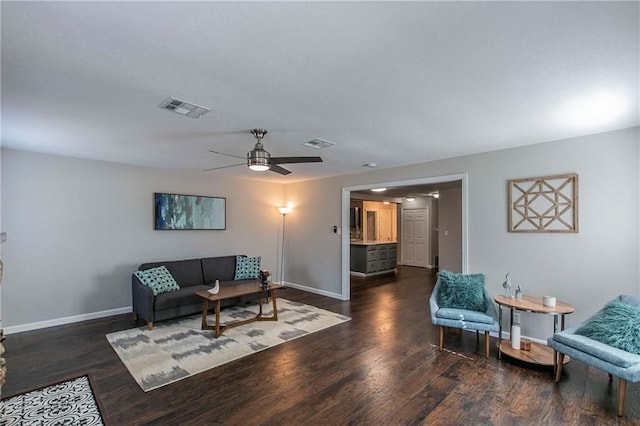 living room featuring dark hardwood / wood-style floors and ceiling fan