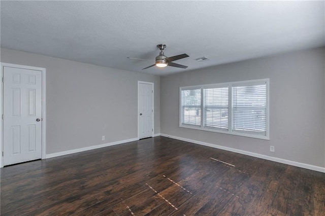 spare room featuring ceiling fan and dark hardwood / wood-style flooring