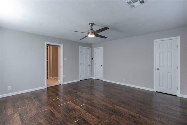 spare room featuring dark hardwood / wood-style flooring and ceiling fan