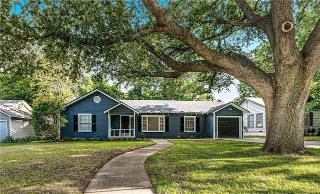 single story home featuring a garage and a front yard