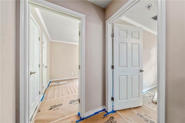 hall featuring light hardwood / wood-style floors and ornamental molding