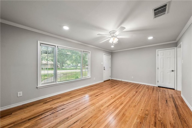 empty room with crown molding, ceiling fan, and light wood-type flooring