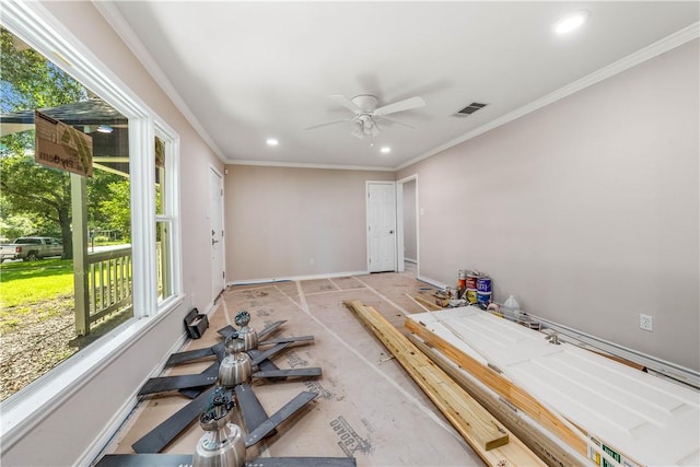 interior space with ceiling fan and ornamental molding