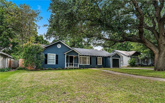 ranch-style house featuring a front yard and a garage