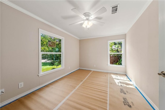 empty room with ceiling fan, wood-type flooring, and ornamental molding