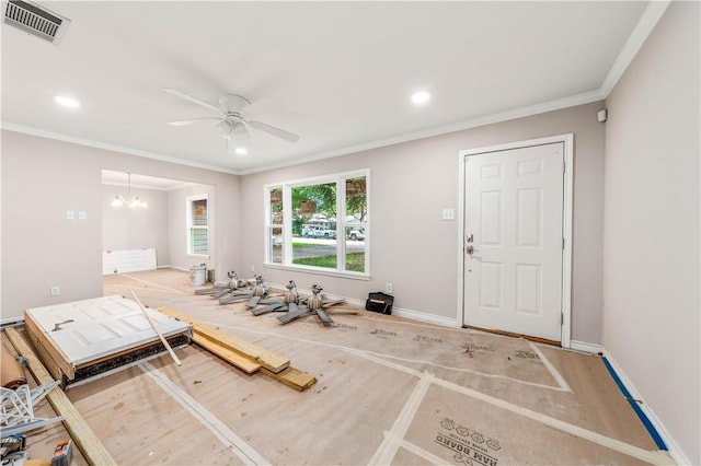 interior space with ceiling fan with notable chandelier and ornamental molding