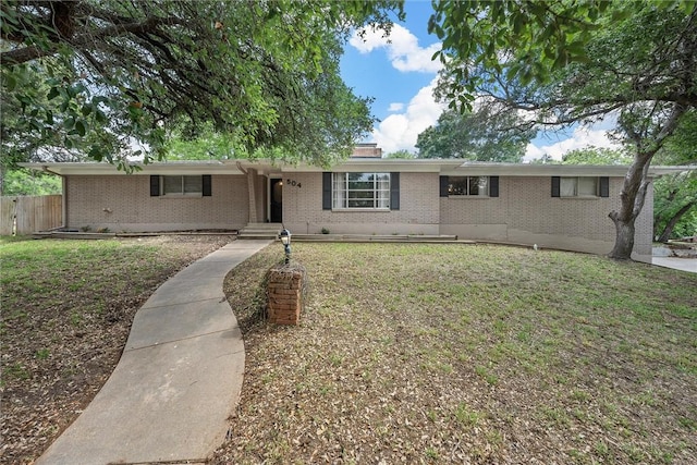 ranch-style house featuring a front yard