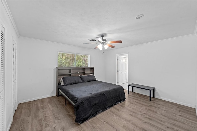 bedroom with ceiling fan, light hardwood / wood-style flooring, and crown molding