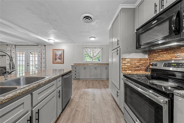 kitchen featuring french doors, stainless steel appliances, gray cabinets, and a healthy amount of sunlight