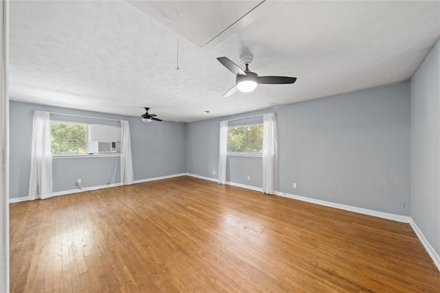 unfurnished room featuring hardwood / wood-style floors, plenty of natural light, and ceiling fan