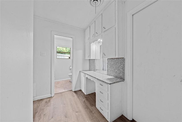 bathroom featuring decorative backsplash, toilet, and hardwood / wood-style flooring