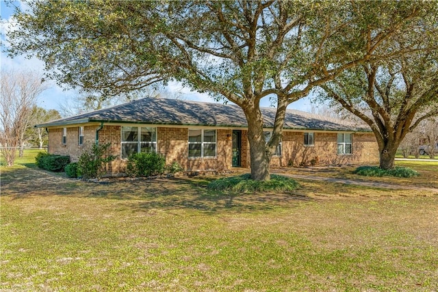 view of front of house with a front lawn and brick siding