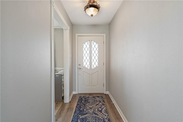 entryway featuring light wood-type flooring and baseboards