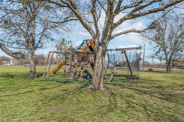 view of jungle gym with a lawn, a trampoline, and fence