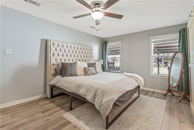 bedroom with baseboards, visible vents, and light wood-type flooring