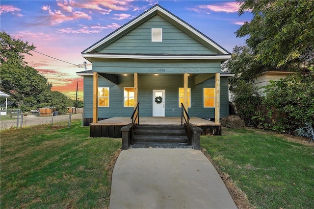 view of front of house featuring a lawn and a porch