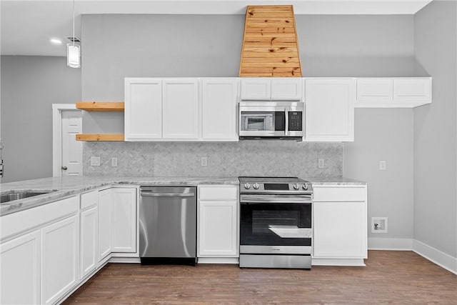 kitchen with dark hardwood / wood-style floors, light stone countertops, white cabinetry, and appliances with stainless steel finishes