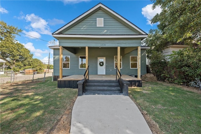 bungalow-style house with covered porch and a front lawn