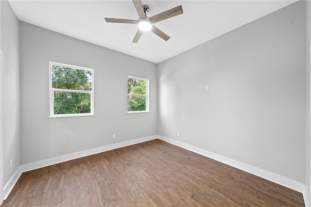 spare room featuring ceiling fan and dark wood-type flooring