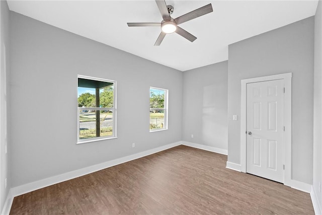 unfurnished room with hardwood / wood-style flooring and ceiling fan