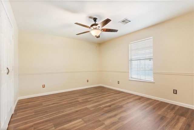 empty room featuring dark hardwood / wood-style floors and ceiling fan