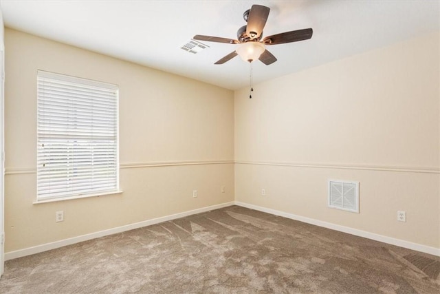 carpeted spare room featuring ceiling fan