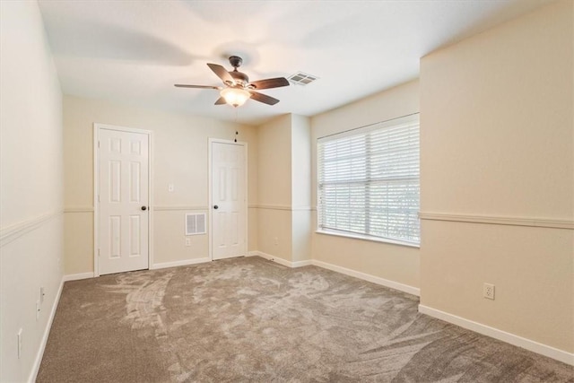 spare room with carpet floors and ceiling fan