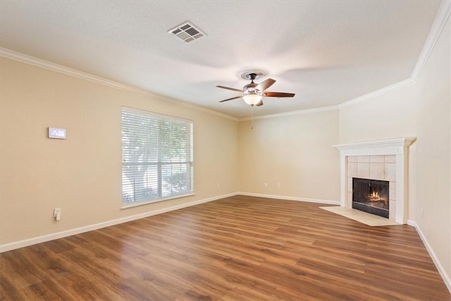 unfurnished living room with hardwood / wood-style floors, crown molding, and a fireplace