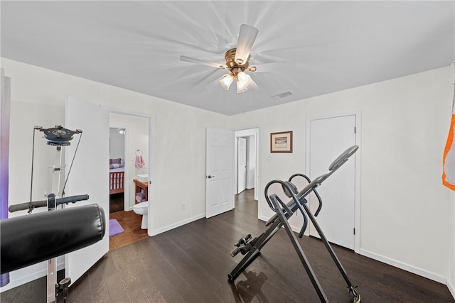 exercise area with dark hardwood / wood-style flooring and ceiling fan