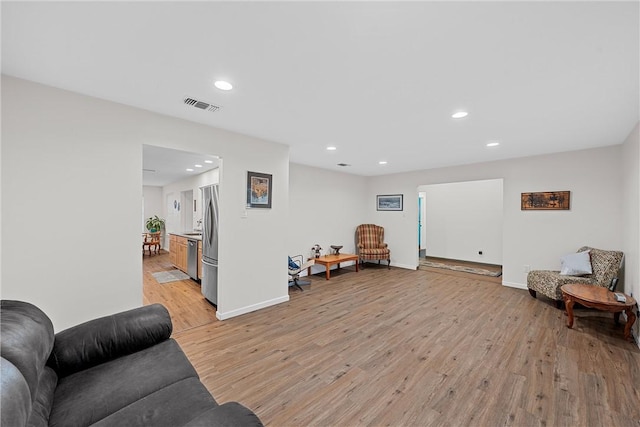 sitting room featuring light hardwood / wood-style floors