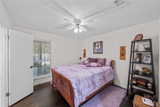 bedroom with dark hardwood / wood-style floors and ceiling fan